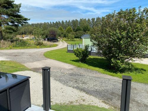 a road leading to a house with a driveway at lake view staycations in Carnforth