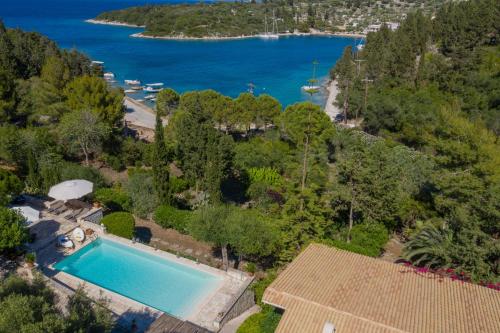 an aerial view of a house with a swimming pool and a lake at Basilica Estate in Porto Ozias