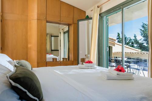 a bedroom with a bed with two cakes on it at Basilica Estate in Porto Ozias