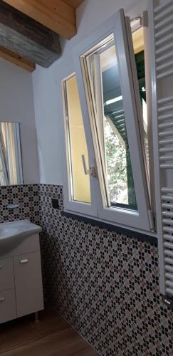 a bathroom with a sink and a window at CASA ELA in Levanto