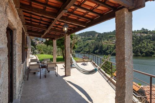 an outdoor patio with a view of a river at Casa do Rio in Escamarão