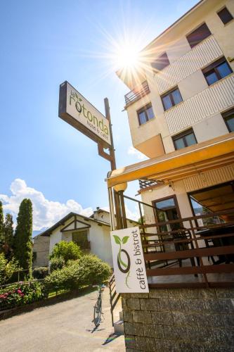 a sign for a hotel in front of a building at Hotel La Rotonda in Tirano