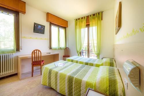 Un pat sau paturi într-o cameră la Hotel La Rotonda