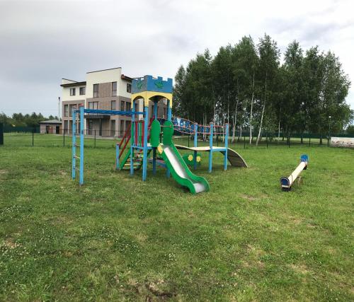 a playground with a slide in a field at Авиатик in Zhytomyr