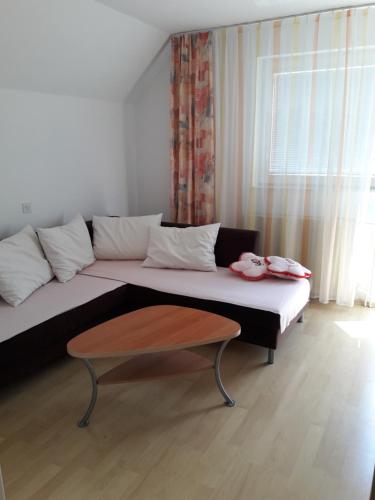 a living room with a couch and a coffee table at Širovnik Apartment in Begunje na Gorenjskem