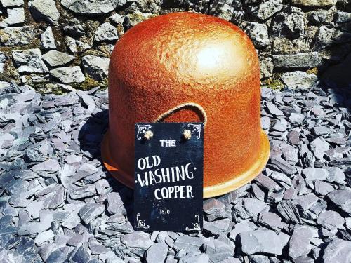 an old mistakingoper sign on a hat on rocks at THE OLD LAUNDRY, Prestatyn, North Wales - a unique little dog-friendly space, a 5 min walk to beach & town! in Prestatyn