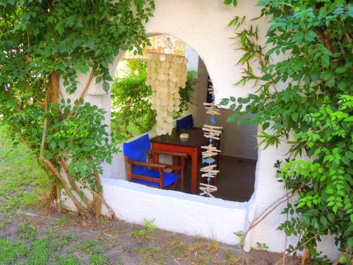 a room with a table and a blue chair at Kalamitsi Studios in Kalamitsi