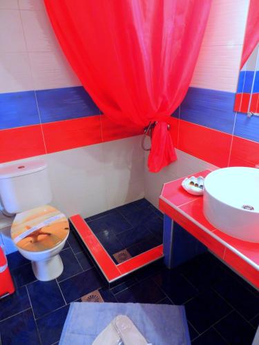a bathroom with a toilet and a sink at Kalamitsi Studios in Kalamitsi