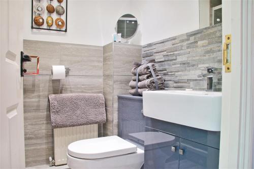a bathroom with a sink and a toilet at Northlands Farm Superior Chalet 3 in Chichester