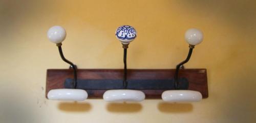 a candle hanging on a wall with three lights at Agriturismo Missanega in Monterosso al Mare