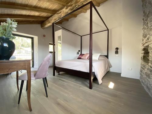 a bedroom with a canopy bed with a table and a desk at Agriturismo Missanega in Monterosso al Mare