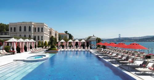 a large swimming pool with chairs and umbrellas at Four Seasons Hotel Istanbul at the Bosphorus in Istanbul