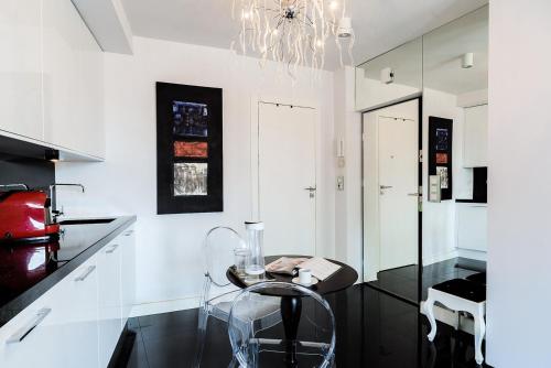 a kitchen with a table and a chandelier at Luxury apartment in the Old town Warsaw in Warsaw