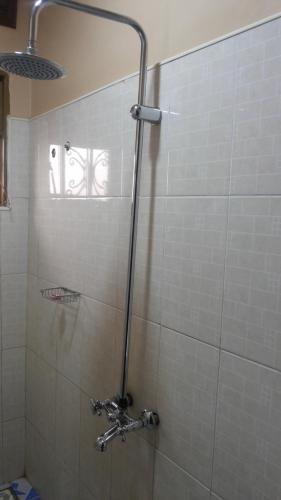 a shower in a bathroom with a glass door at Rock Shadow Hotel in Koboko