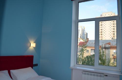 a bedroom with a bed and a large window at Arena,VIP in Kyiv