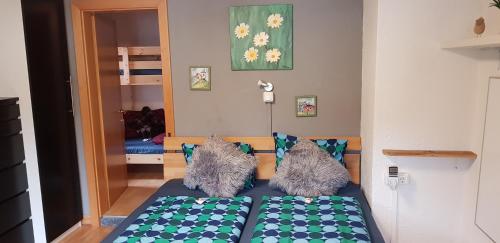 a bedroom with a bed with two pillows at Chalet am Park in Piesendorf