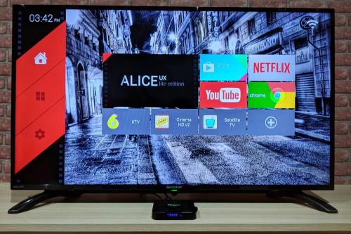 a flat screen tv sitting on top of a table at i-City-Casa Joy - Wifi, Netflix - Movies, Parking, Sleeps 7 Pax in Kampong Padang Jawa