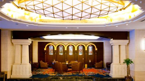 a dining room with a table and chairs in a building at Crowne Plaza Deqing Moganshan by IHG in Deqing