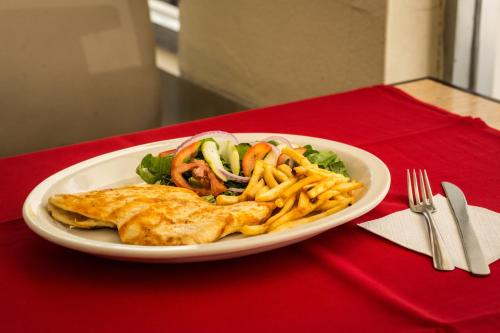 a plate of food on a red table at Hotel María Eugenia Tuxtla Gutiérrez in Tuxtla Gutiérrez