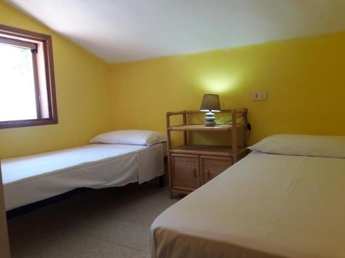 Una cama o camas en una habitación de Chia Zeffiro