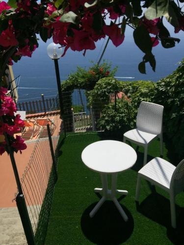 a table and two chairs on a balcony with a view of the ocean at Villa le Arcate in Furore