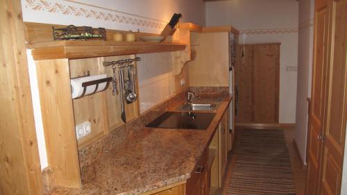 a kitchen with a sink and a counter at Landhaus Am Arzbach in Bad Tölz