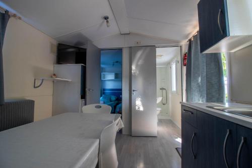 a kitchen with a white counter top and a refrigerator at Mobile homes Bonaca in Srima