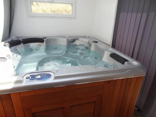 a bath tub in a bathroom with a sink at Gite de Champ Chaulier in Crots