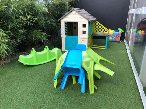 a playground with a table and chairs and a play house at Villa Nautica in Łeba