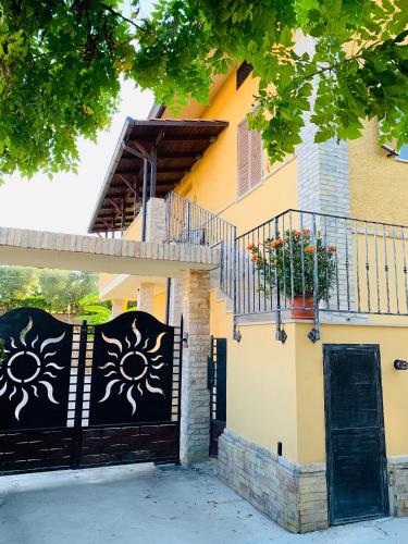 a house with a black gate and a balcony at Flowery House in Miglianico
