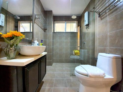 a bathroom with a sink and a toilet and a shower at Gold Coast Morib Studio l Apartment I Penthouse in Banting