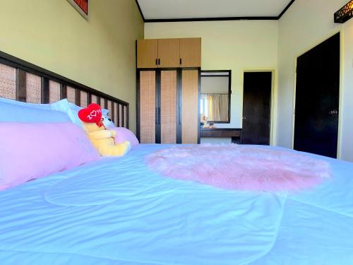 a bed with a stuffed animal sitting on top of it at Gold Coast Morib Studio l Apartment I Penthouse in Banting