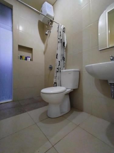 a bathroom with a toilet and a sink at House at Taman Dayu in Pasuruan