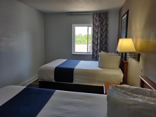 a hotel room with two beds and a window at Cedar Cove in Sandusky