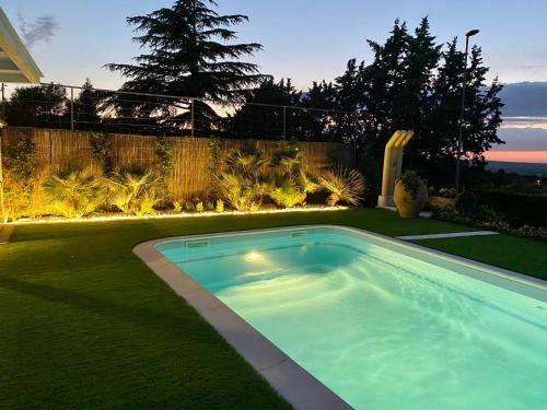 a swimming pool in the yard of a house at In Villa Cielo in Cassano delle Murge