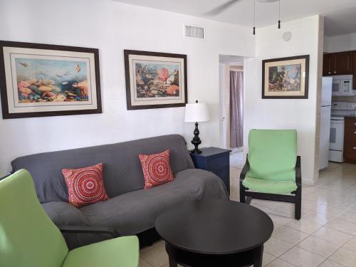 a living room with a couch and a table and chairs at Breakaway Inn Guest House in Fort Lauderdale