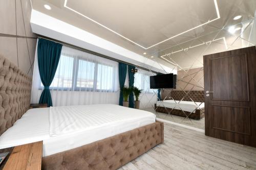 Un dormitorio con una cama grande y un televisor. en Sweet Luxury - CentralPark, en Galaţi