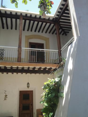 a view of the outside of a house with a balcony at Jardim dos Aloés, Unique B&B - Casa de Charme in Ilha de Moçambique