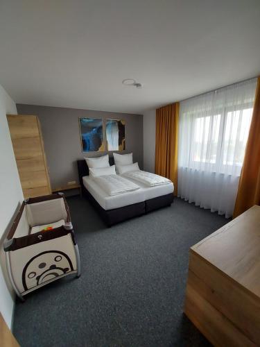 a hotel room with two beds and a suitcase at Ferienwohnung Nikolena in Pirmasens