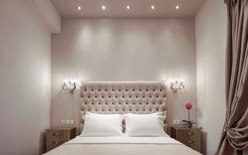 a bedroom with a large bed and two night stands at Eleana Luxury Private Apartment in Neos Marmaras