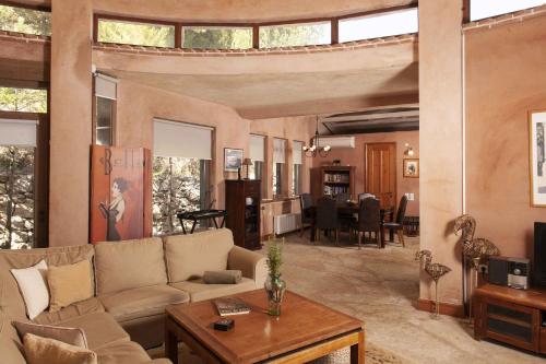 a living room with a couch and a table at Mounty Island Villas Avra-Calma in Lazaráta