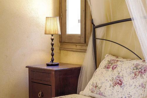 a bedroom with a bed and a lamp on a table at Mounty Island Villas Avra-Calma in Lazaráta
