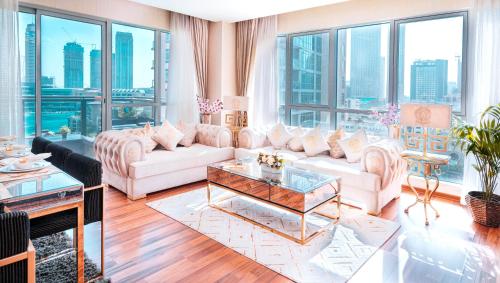 a living room with white furniture and large windows at Elite Royal Apartment - Burj Residences T5 | VIP in Dubai