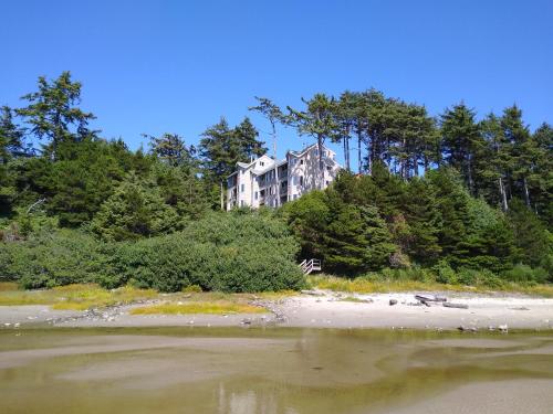 a large house on top of a hill with trees at Starfish Point in Newport