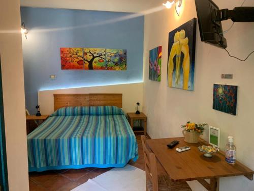 a bedroom with a bed and a wooden table at A Due Passi Da in Aci SantʼAntonio