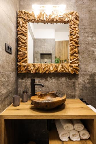 a bathroom with a wooden sink and a mirror at Apartment Sun n' Sea in Sveti Petar