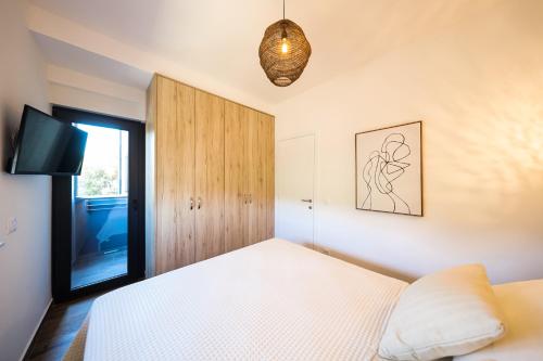a bedroom with a bed and a flat screen tv at Apartment Sun n' Sea in Sveti Petar