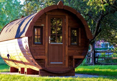 a small wooden hobbit house sitting in a park at Hausdeich in Hamburg