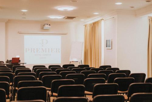 a lecture room with a screen and chairs at Premier Geneva Hotel in Odesa