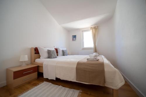 Ένα ή περισσότερα κρεβάτια σε δωμάτιο στο Apartments A&T